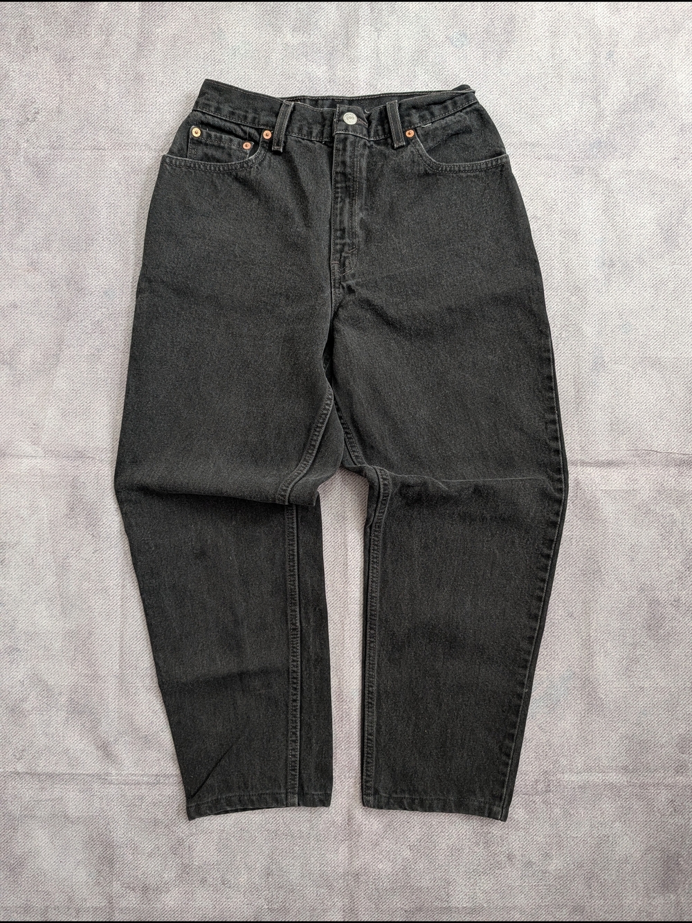 Vintage 90's Levi's 550 Relaxed Tapered jeans in a faded black/dark grey wash.